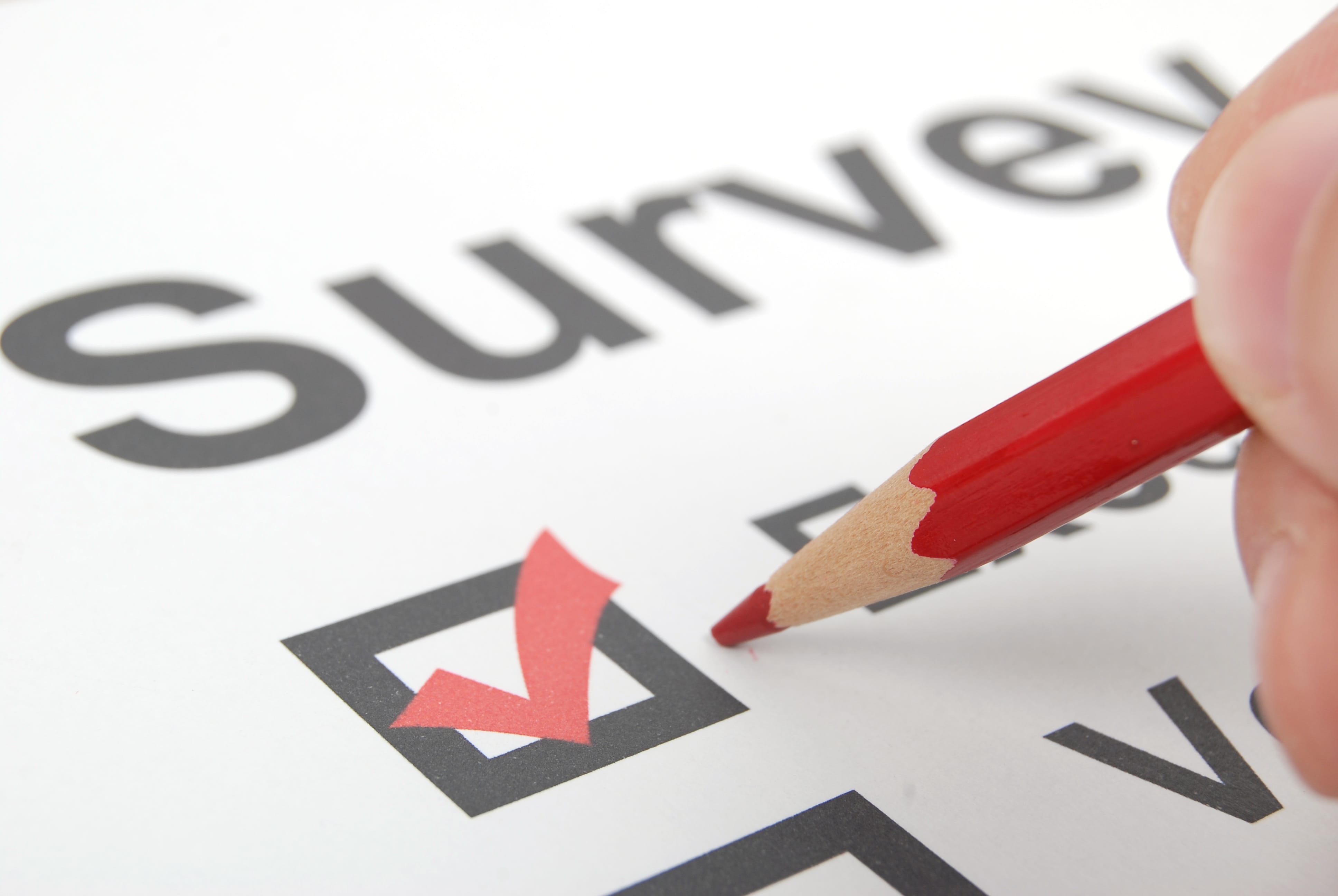 The word Survey with boxes with checks in the below the word