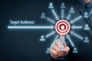 Target audience concept. Businessman click on target audience pointing to target is around target.
