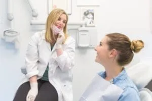 A dentist and a patient during an examination in a dental office.