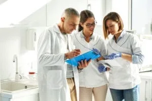 dental assistant helping dentist