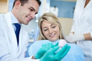 Dentist providing a second opinion consultation to a patient in the dental chair.