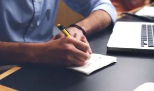A group of professionals taking notes during a business conference.