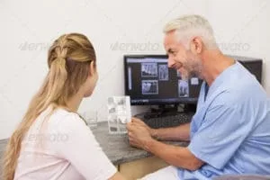 Dentist and patient in consultation about treatment plan.
