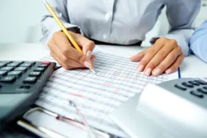 Financial organization with documents, calculator, and charts on a desk.