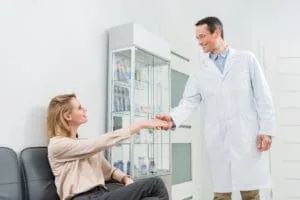 Dentist consulting with patient in office.