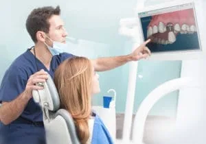 patient and dentist reviewing treatment options on tablet
