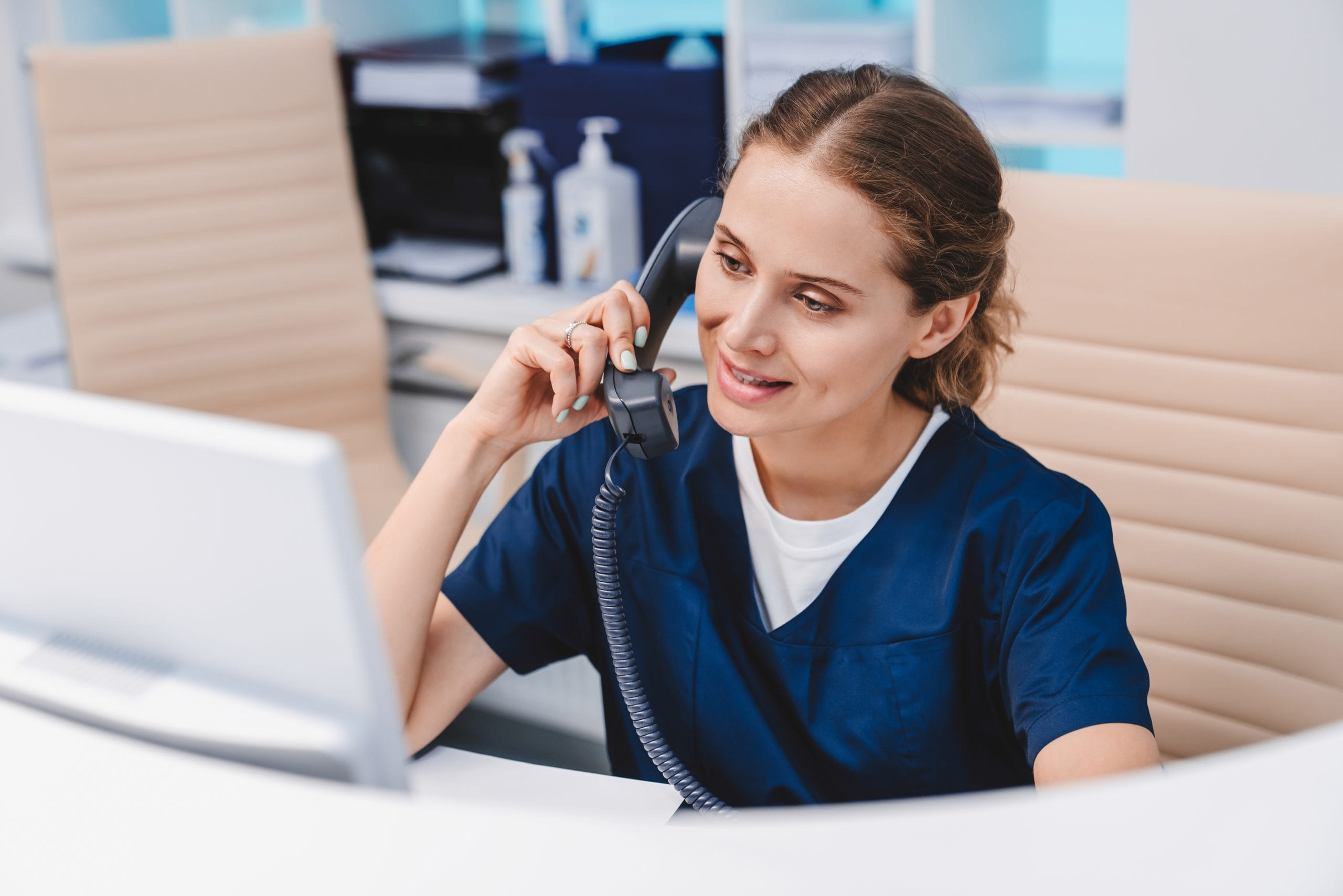 Woman on the phone at the front desk