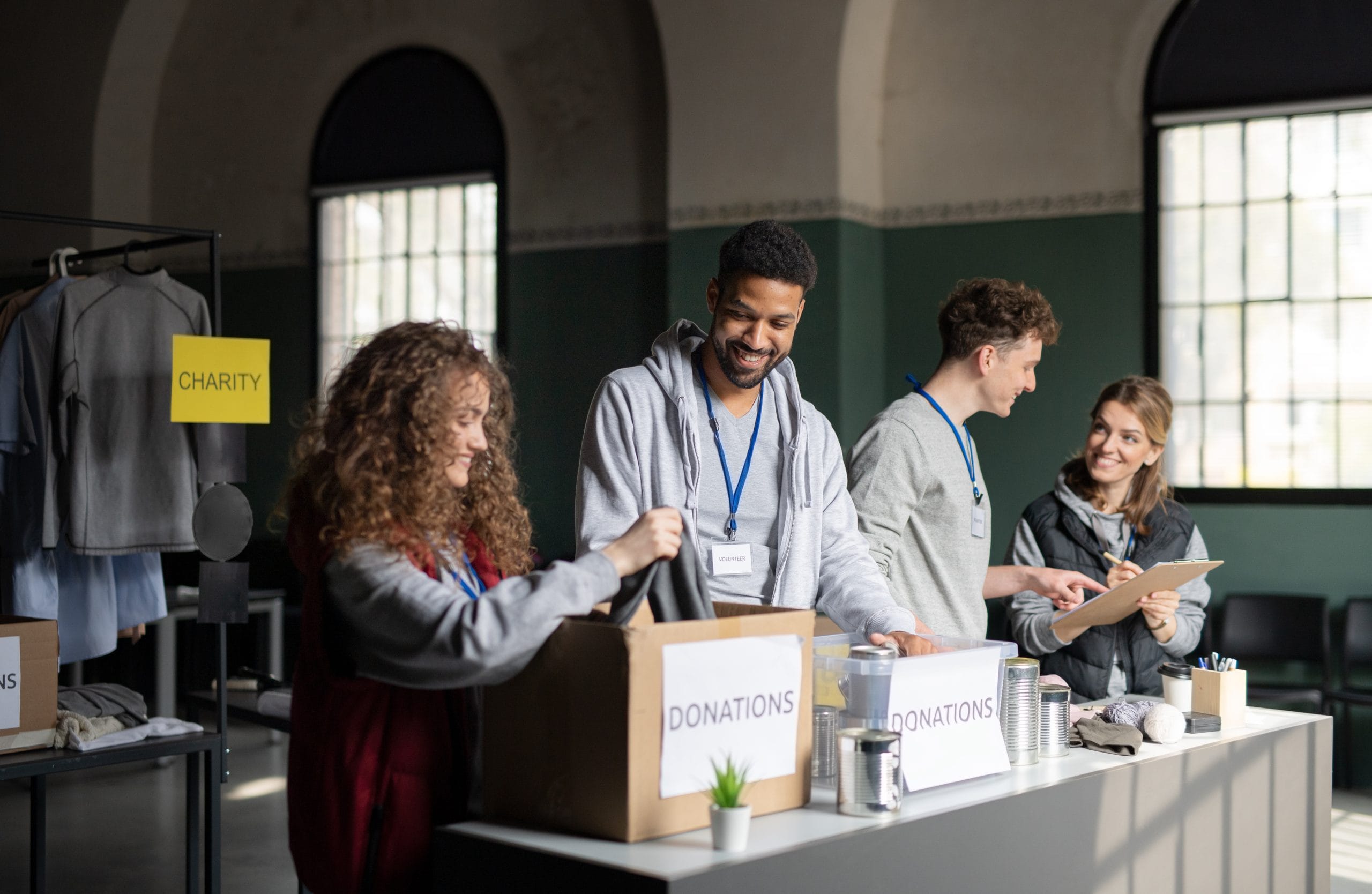 Men and women at a table with boxes that have the word donations on them