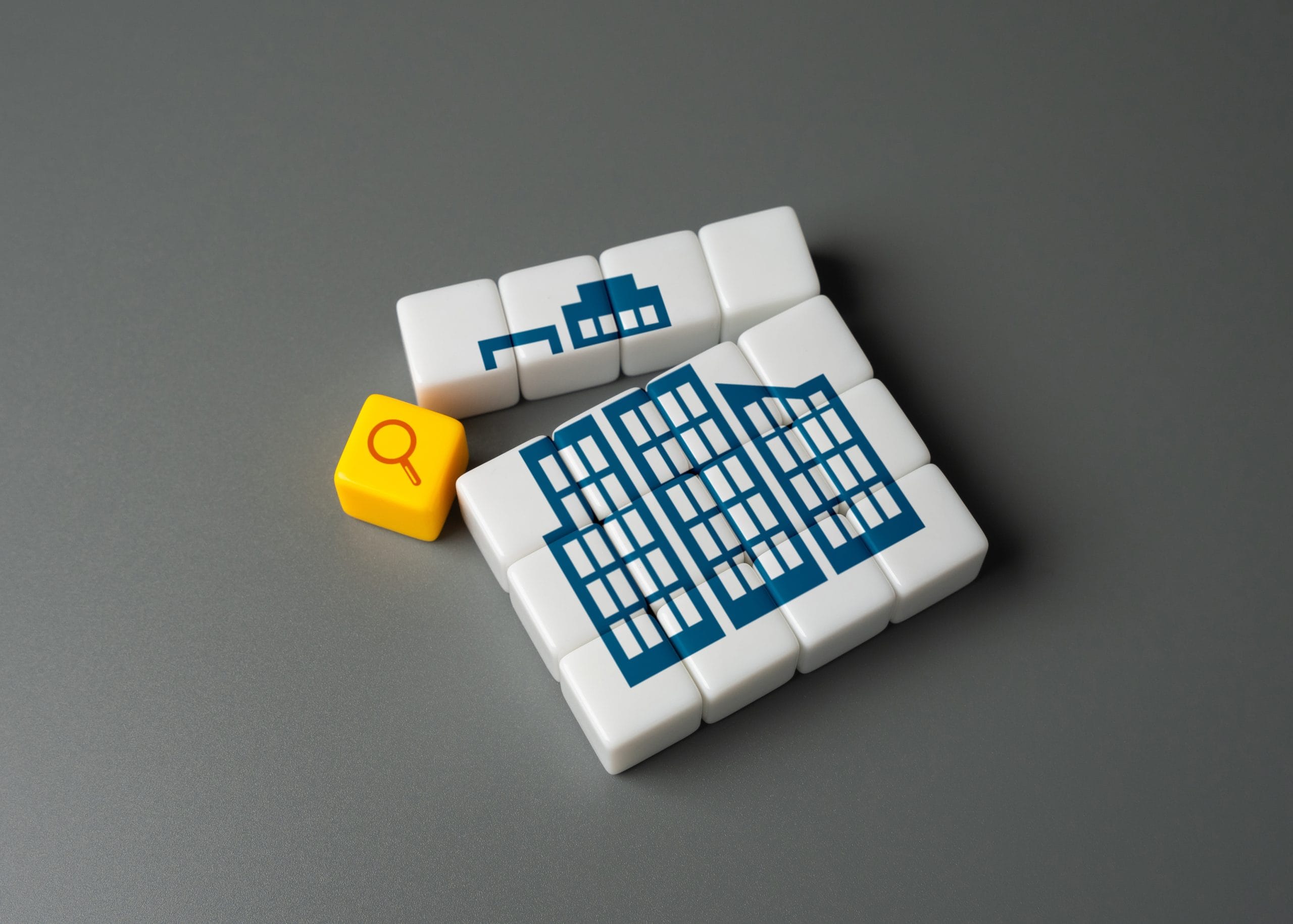 Blocks that make a blue building image and a magnifying glass icon on one block
