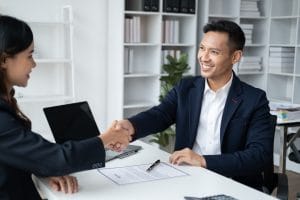 Smiling manager shaking hands with an applicant