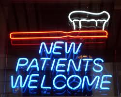 Neon sign that depicts a toothbrush and the words 'new patients welcome'